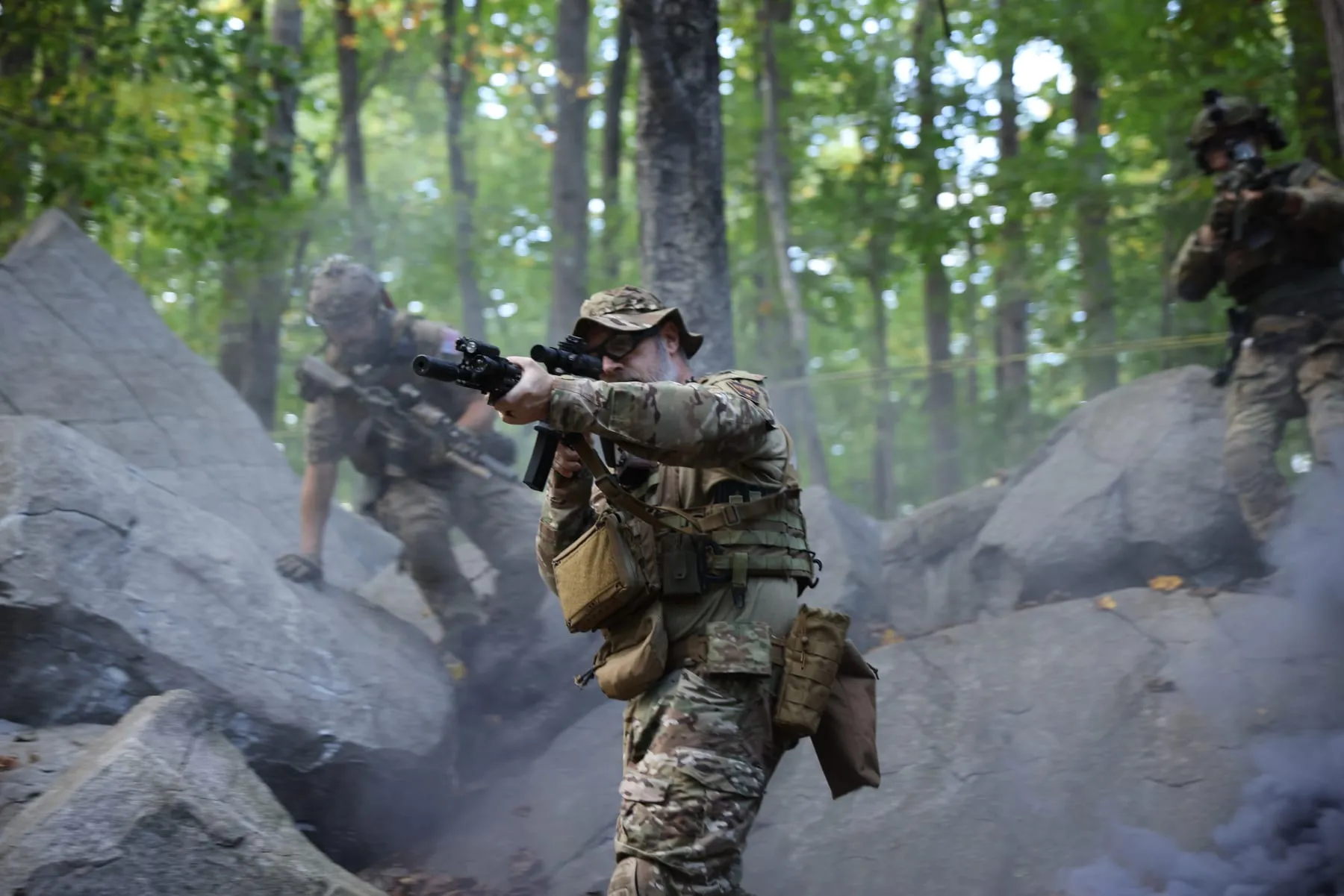 Player climbing through the rocks with his rifle up