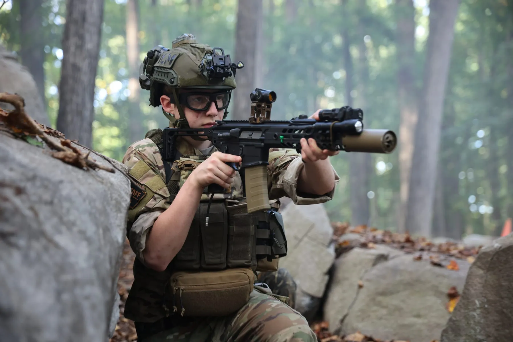 Player aiming from cover behind boulders